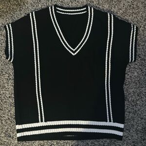Woman’s Acrylic vneck sweater vest. In black and white, size L